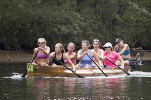 Seven Smitties navigate their war canoe along the shallow Raquette River.