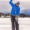 A man standing on a frozen lake with a sampling tool