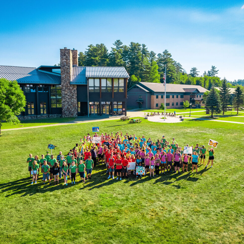 Group of students standing on a green field
