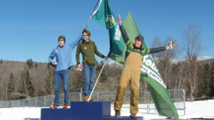 Three people standing on a podium
