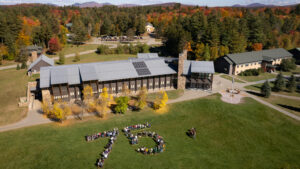 A building with a group of people on a lawn