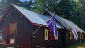 A brown building with a flag.