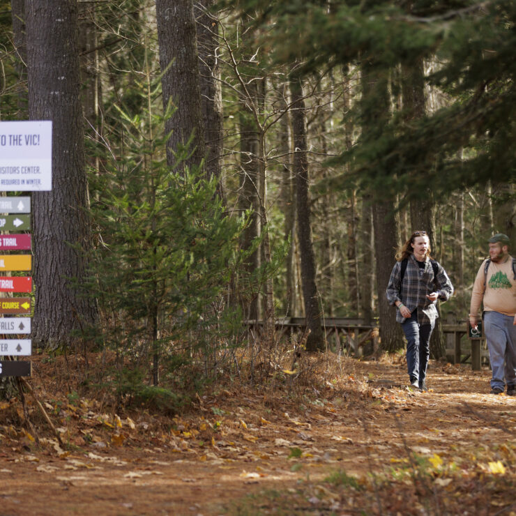 Two people walking on a trail