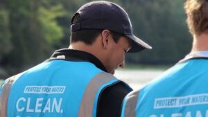 Two people wearing blue vests