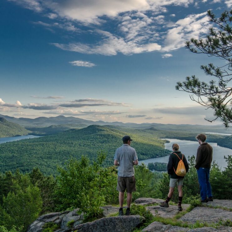 Three people on a mountain summit