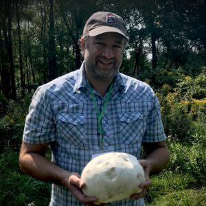 A man holding a potato